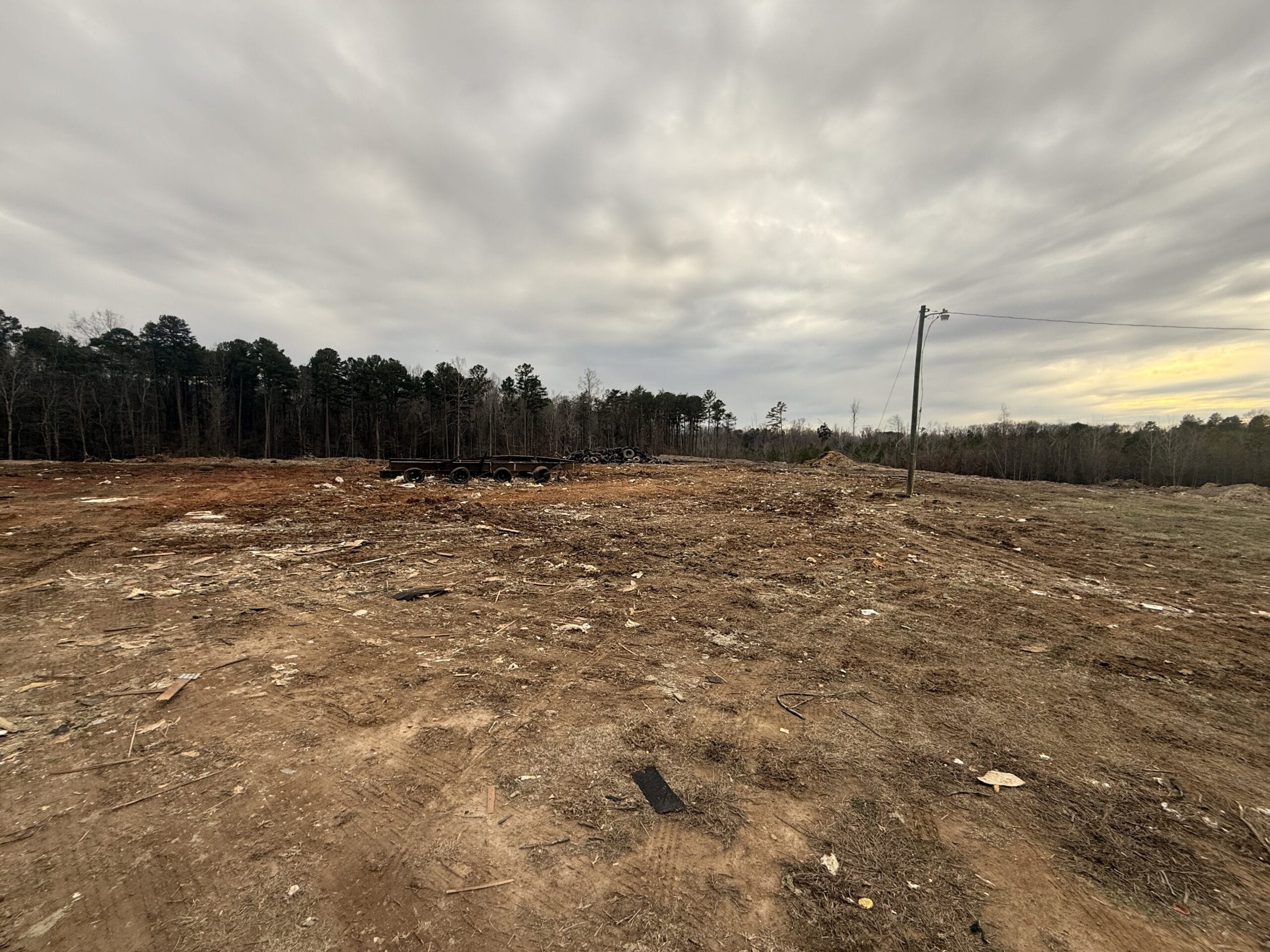 Cleared site after 316 Tree Services hauled the debris, only the metal frame and wheels left